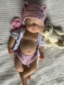 a sleeping reborn doll girl made of silicone 
